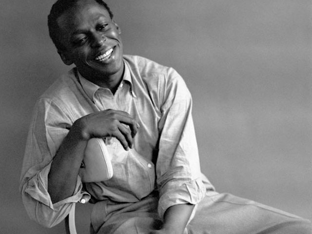 Miles Davis looking fly in a white Oxford shirt